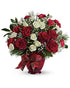 Holiday splendor bouquet in ruby vase with ribbon
