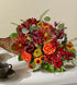 Autumn Herald Cornucopia with orange roses, bronze pompons and red leucadendron