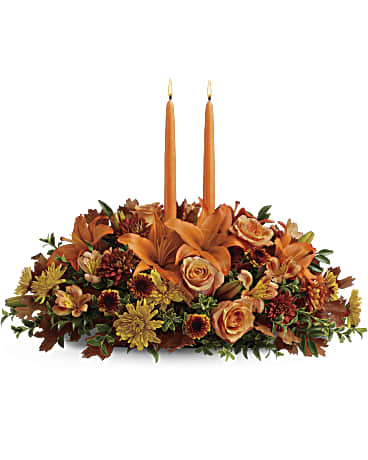 Family Gathering Thanksgiving centerpiece with orange roses, lilies and two taper candles