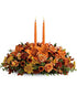 Family Gathering Thanksgiving centerpiece with orange roses, lilies and two taper candles