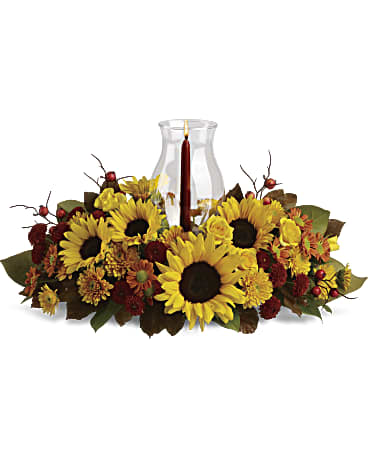 Sunflower Centerpiece with sunflowers, bronze daisies and mums around a glass hurricane