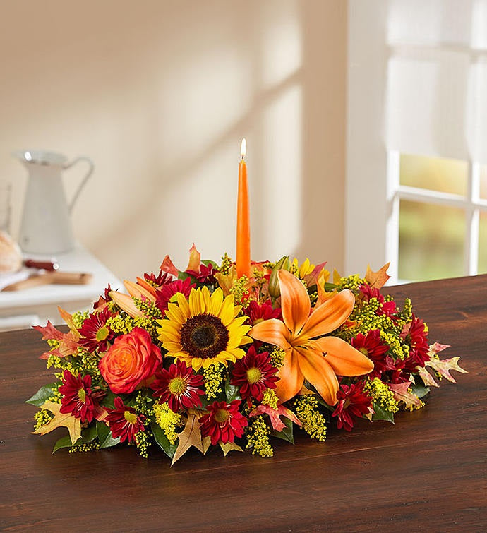 Thankful Harvest fall centerpiece with autumn flowers and an orange candle