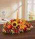 Thankful Harvest fall centerpiece with autumn flowers and an orange candle